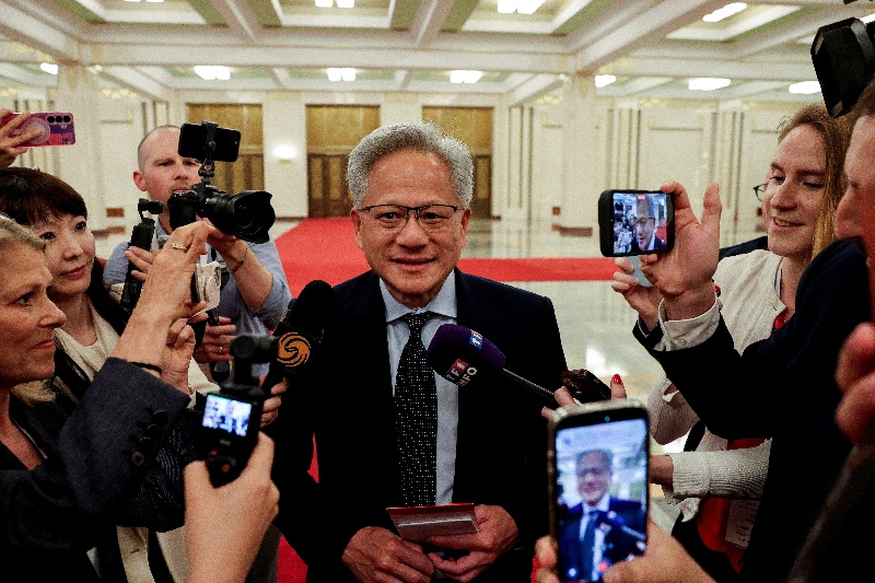 Nvidia CEO Jensen Huang speaks to the media on the day he attends a meeting between Chinese Premier Li Qiang and U.S. business representatives, at the Great Hall of the People in Beijing, China May 14, 2026. REUTERS/Go Nakamura/Pool