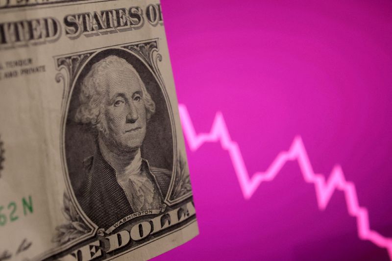 A U.S. dollar banknote and decreasing stock graph are seen in this illustration taken, April 4, 2025. REUTERS/Dado Ruvic/Illustration