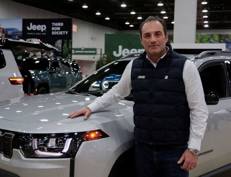 Stellantis CEO Antonio Filosa poses by a Jeep Cherokee during media day of the Detroit Auto Show in Detroit, Michigan, U.S. January 14, 2026.  REUTERS/Rebecca Cook