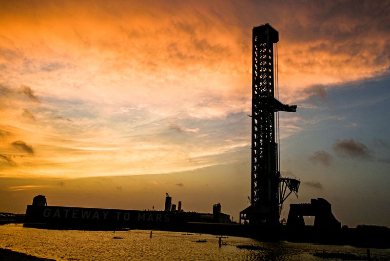 The sun rises before preparations continue at launch pad 2 for the 12th test flight of SpaceX's Starship spacecraft and the Super Heavy booster in Starbase, Texas, U.S., May 18, 2026. In addition to being the inaugural voyage of both the V3 Starship and Super Heavy, the upcoming launch will mark the first blastoff from the new launch pad designed for the more powerful rocket. REUTERS/Steve Nesius