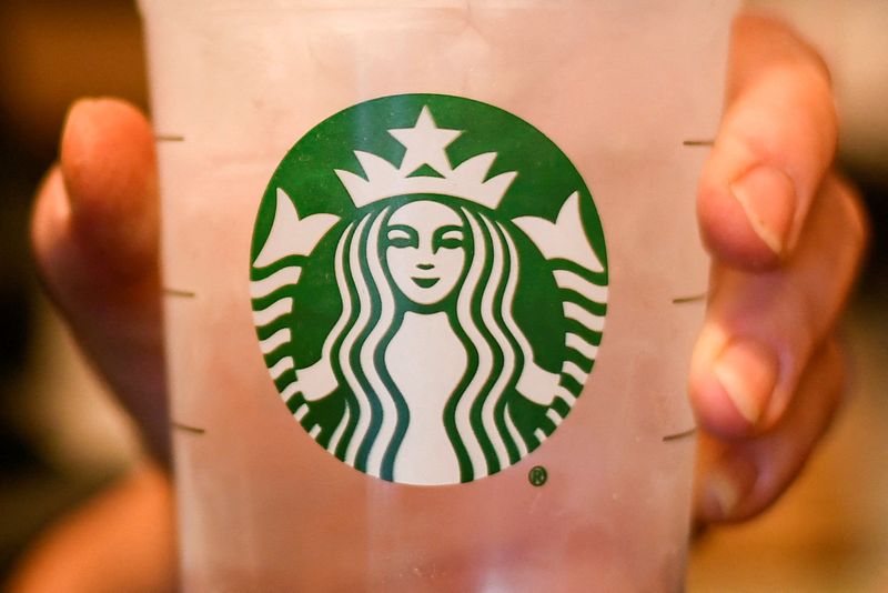 FILE PHOTO: An employee poses with a cup of water at a Starbucks coffeehouse in Austin, Texas, U.S., February 10, 2017. REUTERS/Mohammad Khursheed/File Photo