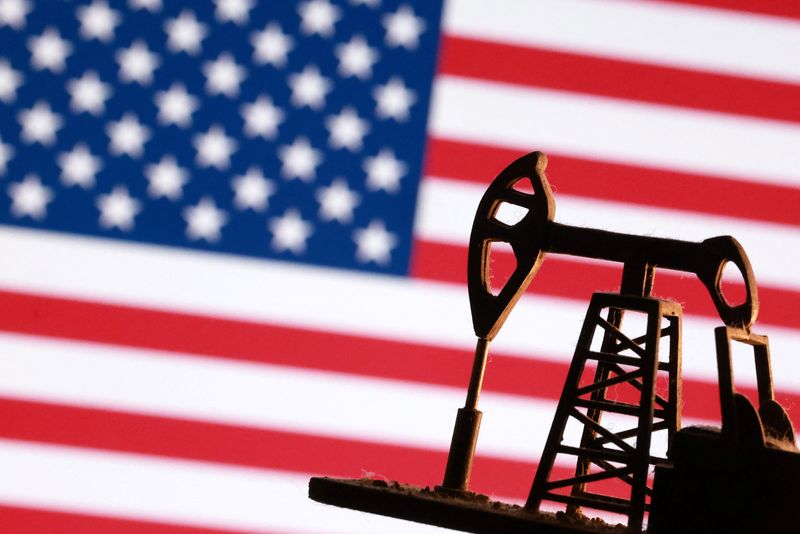 A model of an oil pump is seen in front of a U.S. flag in this illustration taken January 9, 2026. REUTERS/Dado Ruvic/Illustration