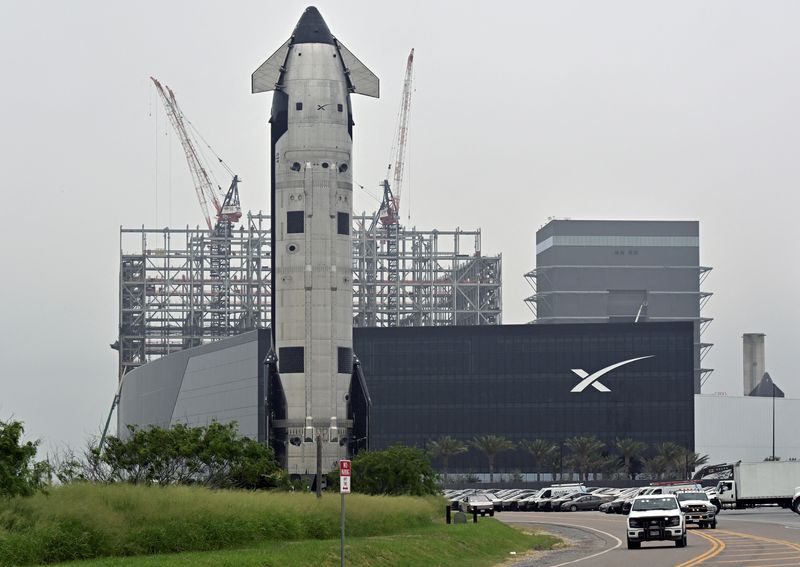The SpaceX Starship spacecraft rolls past the production facility toward launch pad 2 ahead of its 12th test flight, in Starbase, Texas, U.S., May 19, 2026. REUTERS/Steve Nesius
