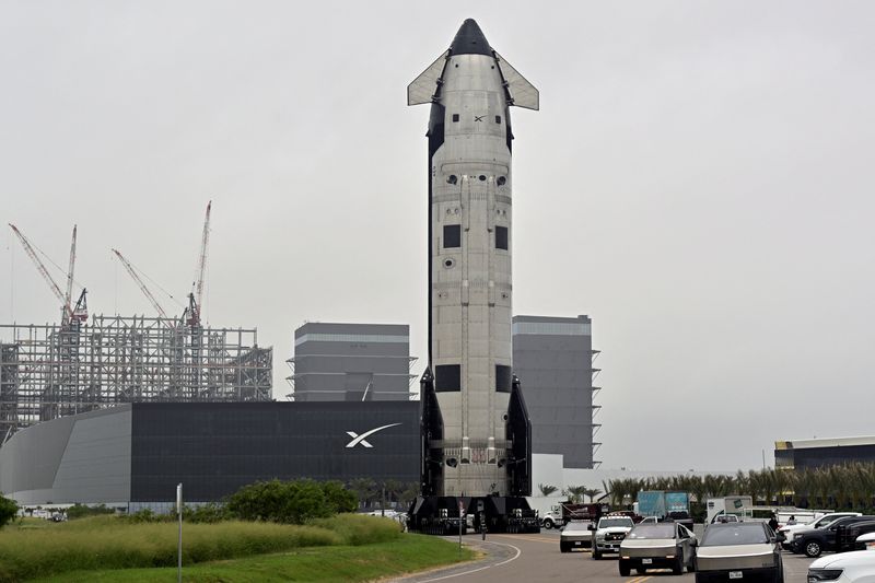 The SpaceX Starship spacecraft rolls past the production facility toward launch pad 2 ahead of its 12th test flight, in Starbase, Texas, U.S., May 19, 2026. REUTERS/Steve Nesius
