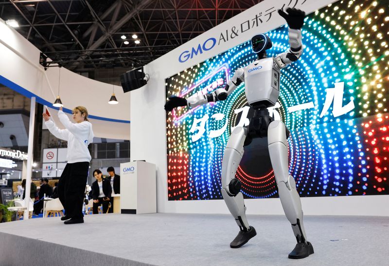 GMO AI and Robotics' humanoid robot Unitree G1 dances alongside a dancer to the music at GMO's booth in the International Robot Exhibition 2025 at Tokyo Big Sight in Tokyo, Japan December 3, 2025. REUTERS/Manami Yamada