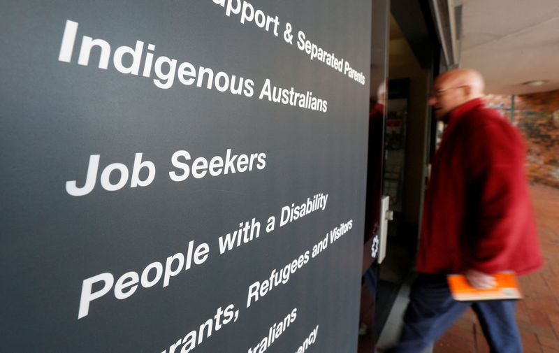 FILE PHOTO: A man walks into a Centrelink office, part of the Australian government's department of human services where job seekers search for employment, in a Sydney suburb, August 7, 2014.  REUTERS/Jason Reed/File Photo