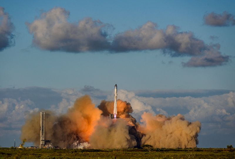 FILE PHOTO: A SpaceX Super Heavy booster carrying the Starship spacecraft lifts off on its 11th test flight at the company's launch pad in Starbase, Texas, U.S., October 13, 2025. REUTERS/Steve Nesius/File Photo