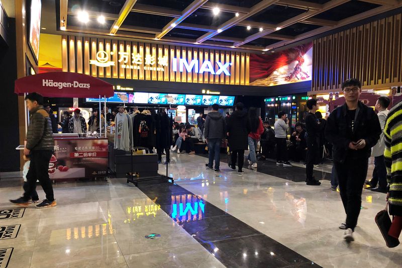 People wait for movie screening at an IMAX theatre inside the Wanda Plaza in Xinxiang, Henan province, China March 23, 2018. REUTERS/Stella Qiu