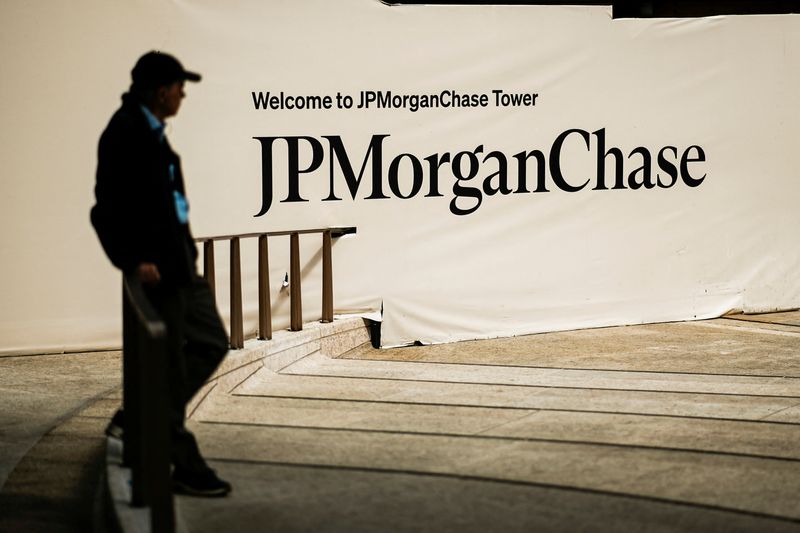 A person waits near one of the entrances of the JPMorgan Chase & Co., headquarters in New York City, U.S., April 1, 2026. REUTERS/Eduardo Munoz