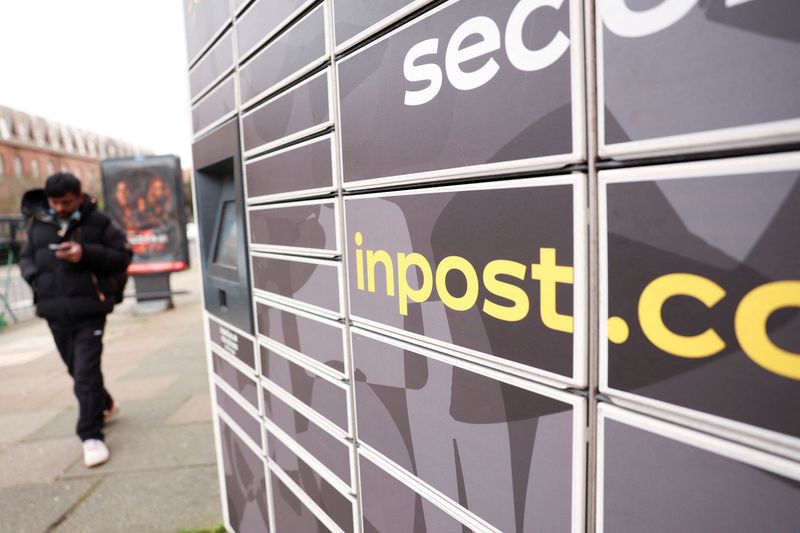 FILE PHOTO: A man walks past an InPost locker after British money manager Aberdeen said it would vote against a $9.2 billion FedEx‑led takeover of InPost, in London, Britain, February 18, 2026. REUTERS/Hiba Kola/File Photo
