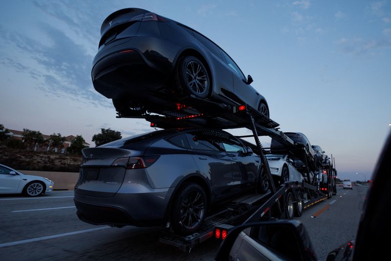 Newly manufactured Tesla Model Y SUV vehicles are transported along a freeway near Carlsbad, California, U.S., September 9, 2024.    REUTERS/Mike Blake