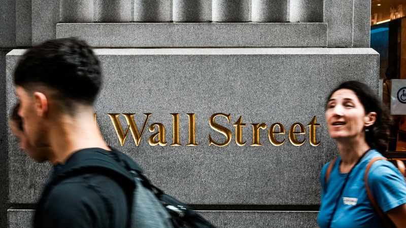 FILE PHOTO: People walk near the New York Stock Exchange (NYSE) in New York City, New York, U.S., August 7, 2025.  REUTERS/Eduardo Munoz/File Photo