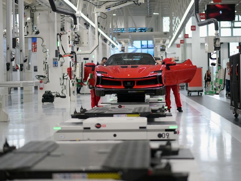 Employees work at Ferrari's new 'e-building' facility, where the luxury sportscar maker is testing lines before an expected start of car production in early 2025, in Maranello, Italy, June 21, 2024. REUTERS/Daniele Mascolo
