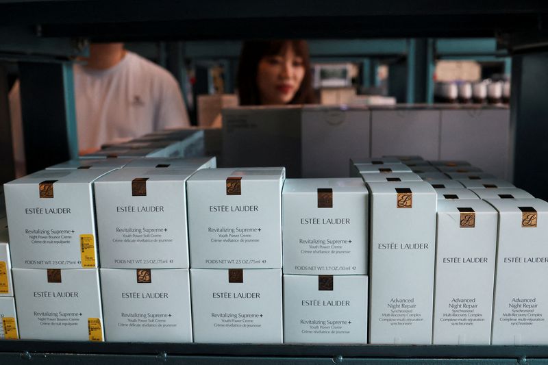 FILE PHOTO: Customers shop near Estee Lauder beauty products displayed at a store in Beijing, China June 10, 2025. REUTERS/Florence Lo/File Photo