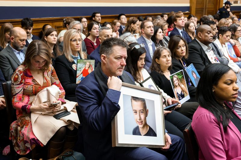Parents hold images of their children, who were harmed by social media, during a House Energy and Commerce Committee markup of nine bills, including the Kids Internet and Digital Safety (KIDS) Act, on Capitol Hill in Washington, D.C., U.S., March 5, 2026. REUTERS/Kylie Cooper