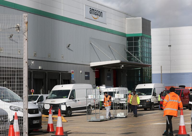 An employee pushes a cart outside an Amazon fulfilment centre, in London, Britain, October 28, 2025. REUTERS/Isabel Infantes