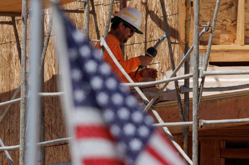 FILE PHOTO: A construction worker is shown at work on a multi-unit residential housing project in Encinitas, California, U.S., July 28, 2025.   REUTERS/Mike Blake/File Photo