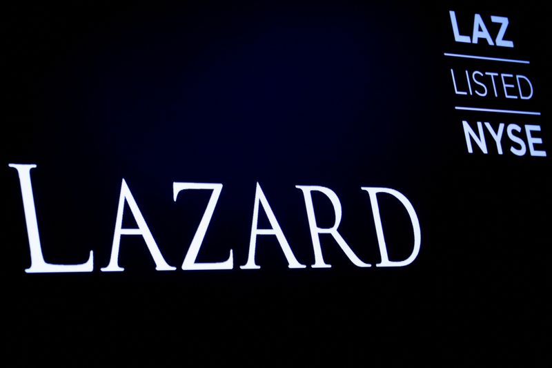 FILE PHOTO: The logo and trading information for Lazard Ltd appear on a screen on the floor at the New York Stock Exchange (NYSE) in New York, U.S., April 24, 2019. REUTERS/Brendan McDermid//File Photo