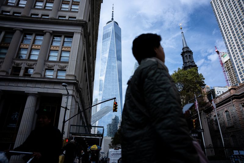 People walk around the Financial District on the morning after Zohran Mamdani’s election win in New York City, U.S., November 5, 2025. REUTERS/Angelina Katsanis