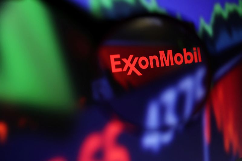 Exxon Mobil logo and stock graph are seen through a magnifier displayed in this illustration taken September 4, 2022. REUTERS/Dado Ruvic/Illustration
