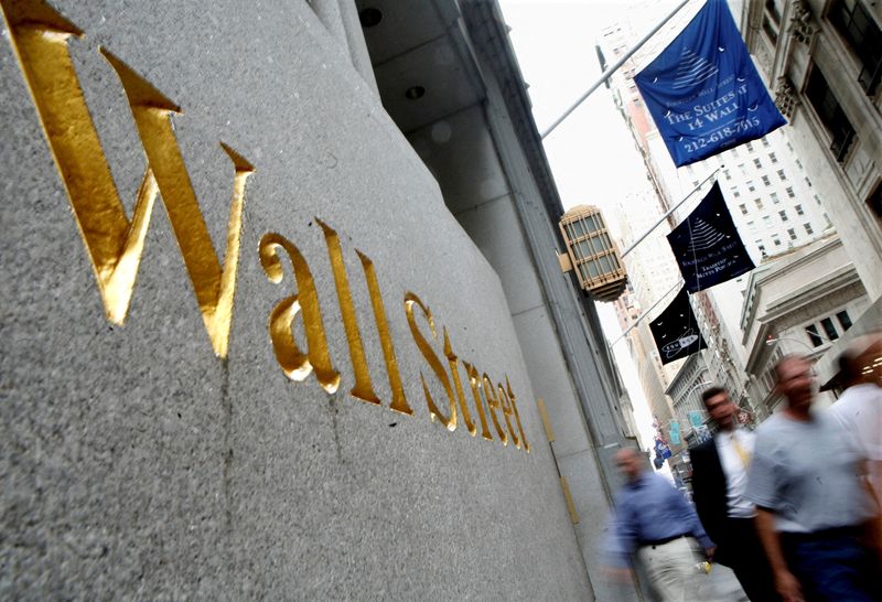 FILE PHOTO: People walk along Wall Street near the New York Stock Exchange July 13, 2007. REUTERS/Brendan McDermid/File Photo/File Photo