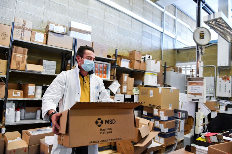 FILE PHOTO: A health worker checks the boxes containing Molnupiravir, MSD's coronavirus disease (COVID-19) treatment pill, at Misericordia hospital, in Grosseto, Italy. February 8, 2022. REUTERS/Jennifer Lorenzini/File Photo