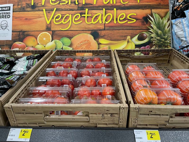 FILE PHOTO: Boxes of tomatoes are seen in a fresh food aisle at a Dollar General store in Norridge, Chicago, U.S., August 24, 2021.  REUTERS/Richa Naidu/File Photo