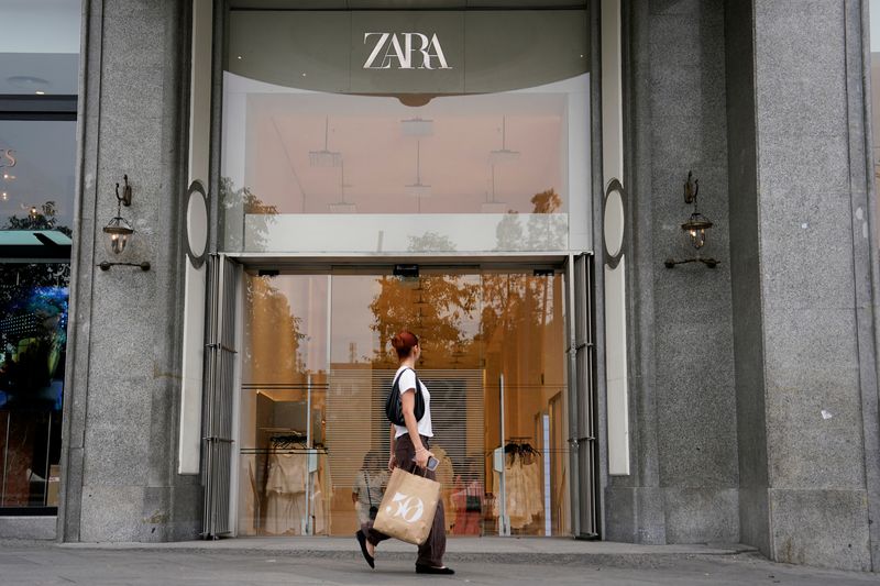 A person carrying a bag walks by a Zara store in Plaza de Espana in Madrid, Spain, June 11, 2025. REUTERS/Ana Beltran