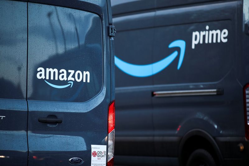 FILE PHOTO: Logos of Amazon and Amazon Prime are pictured on vehicles outside the Amazon Fulfilment Centre in Altrincham, near Manchester, Britain, November 26, 2021. REUTERS/Carl Recine/File Photo
