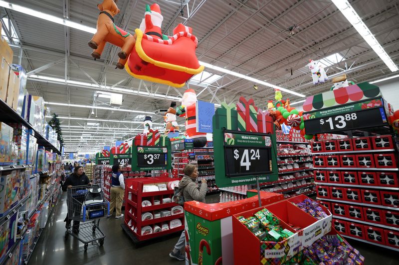 Customers walk through holiday shopping displays at a Walmart Supercenter retail store in North Bergen, New Jersey, U.S., November 21, 2025.  REUTERS/Mike Segar