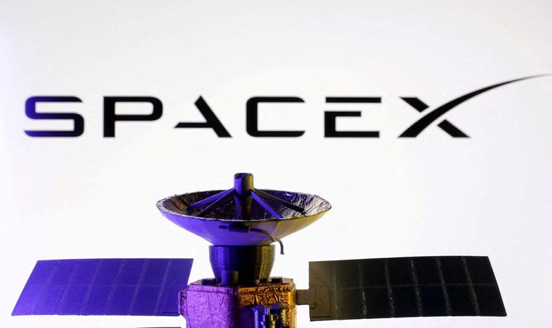 FILE PHOTO: SpaceX logo and miniature satellite model are seen in this illustration created on March 10, 2025. REUTERS/Dado Ruvic/Illustration/File Photo