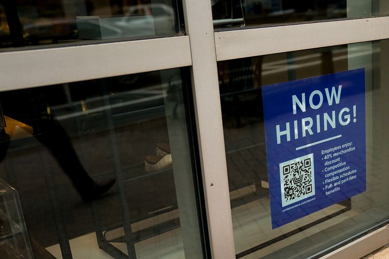 An employee hiring sign with a QR code is seen in a window of a business in Arlington, Virginia, U.S., April 7, 2023. REUTERS/Elizabeth Frantz
