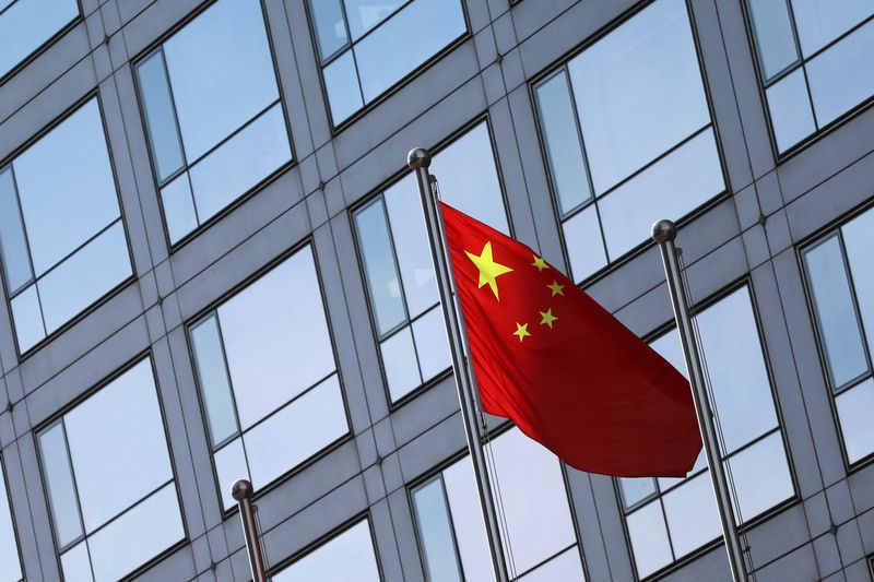 A Chinese flag flutters outside the China Securities Regulatory Commission (CSRC) building on the Financial Street in Beijing, China February 8, 2024. REUTERS/Florence Lo