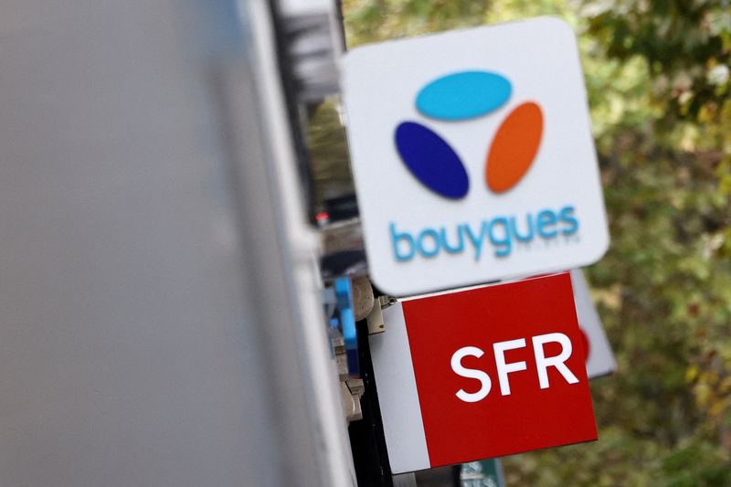 FILE PHOTO: The logos of French telecom operators Bouygues and SFR are seen on shops in Paris, France, October 15, 2025. REUTERS/Sarah Meyssonnier/File Photo