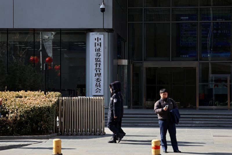 Police officers patrol outside the China Securities Regulatory Commission (CSRC) building on the Financial Street in Beijing, China February 8, 2024. REUTERS/Florence Lo