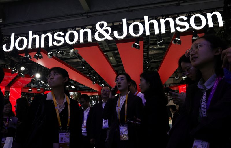 People gather next to a logo of Johnson & Johnson at the company’s booth at the 8th China International Import Expo (CIIE) in Shanghai, China, November 6, 2025.REUTERS/Maxim Shemetov