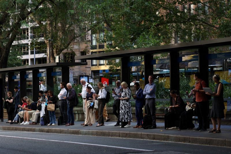 FILE PHOTO: Commuters queue for buses during peak hour outside Wynyard Station in Sydney, Australia, March 25, 2026. REUTERS/Hollie Adams/File Photo