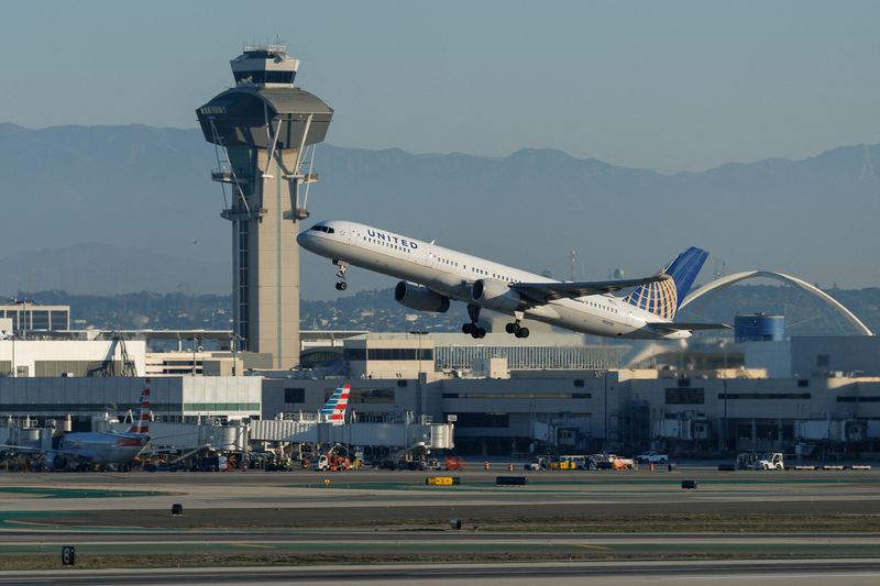 FILE PHOTO: A United Airlines commercial airliner takes-off from Los Angeles International Airport in Los Angeles, California, U.S., November 6, 2025. REUTERS/Mike Blake/File Photo