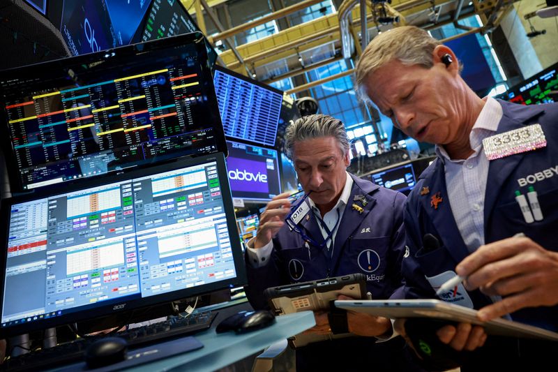 FILE PHOTO: Traders work on the floor at the New York Stock Exchange (NYSE) in New York City, U.S., June 3, 2026.  REUTERS/Brendan McDermid/File Photo