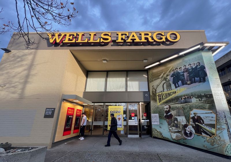 FILE PHOTO: A man walks from a branch of Wells Fargo bank in the University District of Seattle, Washington, U.S. December 6, 2024. REUTERS/Chris Helgren/File Photo