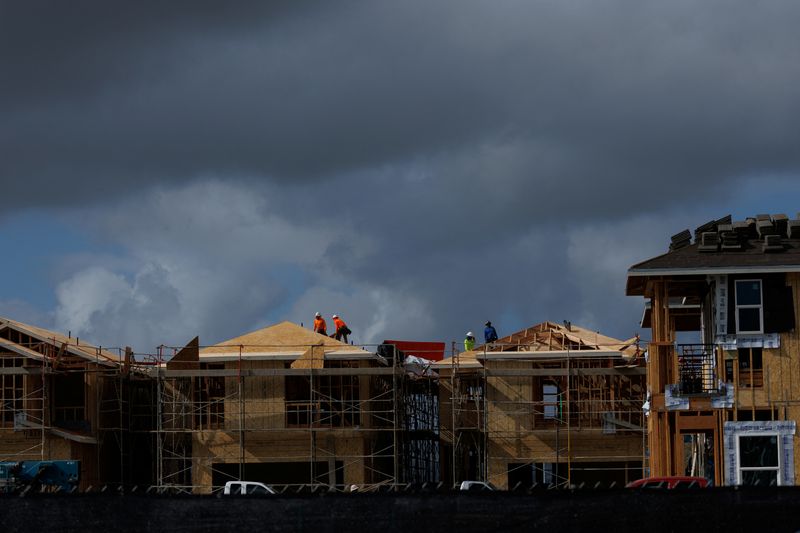 Construction workers use wood and lumber to build residential homes in Irvine, California, U.S., March 28, 2025.  REUTERS/Mike Blake