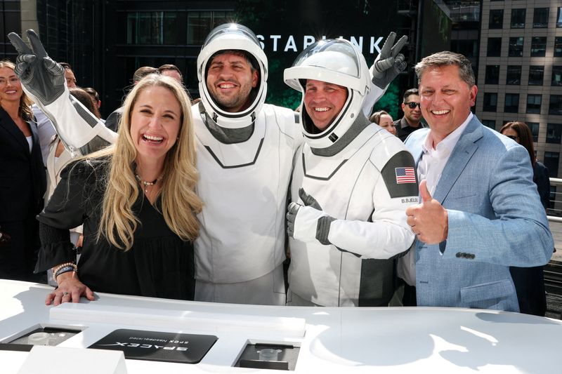 FILE PHOTO: SpaceX Vice President for Human Resources Brian Bjelde, wearing a SpaceX spacesuit, and others celebrate on the balcony after the closing bell at the Nasdaq MarketSite, on the day of SpaceX's initial public offering (IPO) in New York City, U.S., June 12, 2026. REUTERS/Brendan McDermid/File Photo