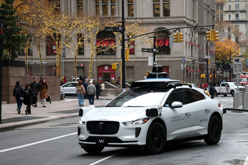 Waymo driverless taxi drives in lower Manhattan in New York City, U.S., November 26, 2025.  REUTERS/Brendan McDermid/File Photo