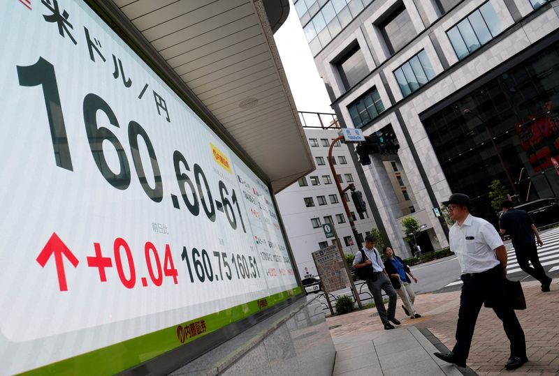 A pedestrian looks at a board showing  the current Japanese yen exchange rates against the U.S. dollar outside a brokerage in Tokyo, Japan, June 18, 2026.    REUTERS/Kim Kyung-Hoon