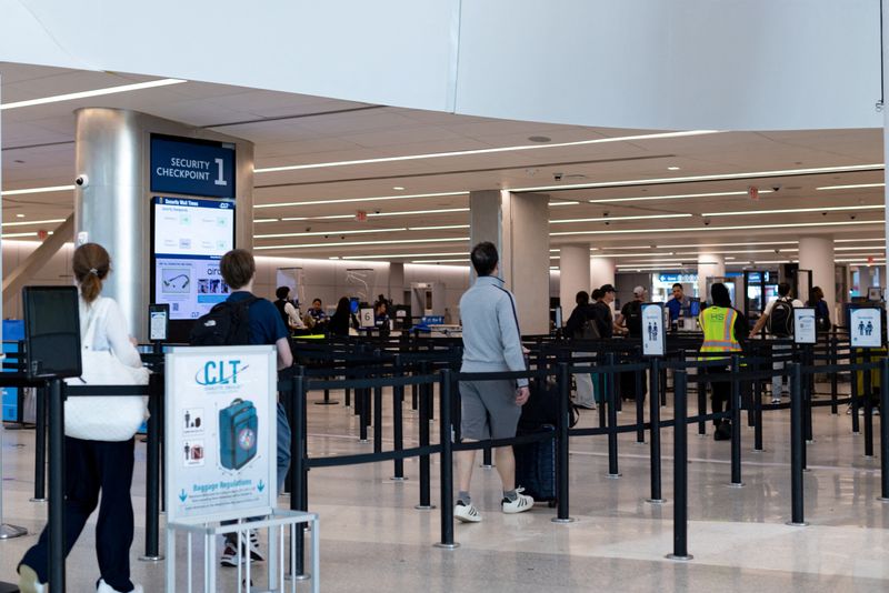 FILE PHOTO: Travellers walk at the Charlotte Douglas International Airport in Charlotte, North Carolina, U.S., March 22, 2026. REUTERS/Kaylee Greenlee/File Photo