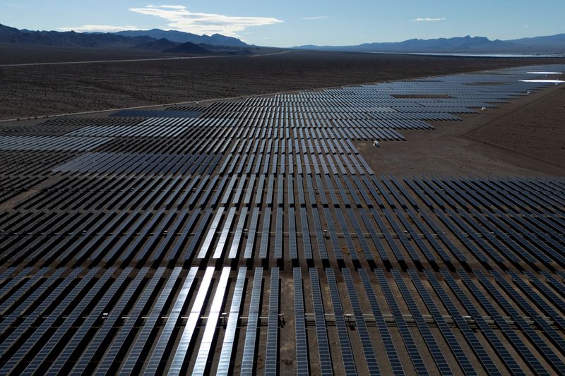 FILE PHOTO: A drone view of sunlight reflecting off solar panels at the Boulder Solar 1 facility in Boulder City, Nevada, U.S., November 23, 2025. REUTERS/Daniel Cole/File Photo