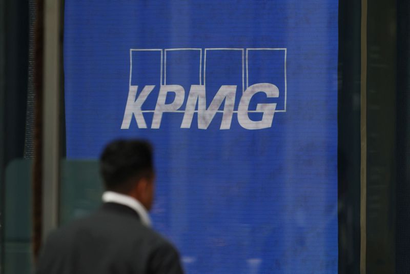 A man walks past a KPMG logo displayed at the company’s headquarters in Sydney, Australia, June 19, 2026. REUTERS/Hollie Adams