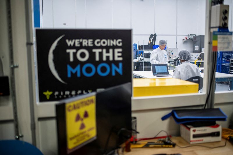 FILE PHOTO: People work in a lab at the Firefly Aerospace mission operations center in Leander, Texas, U.S., July 9, 2025.   REUTERS/Sergio Flores/File Photo
