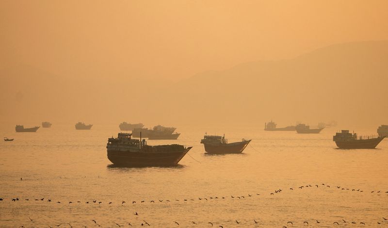 FILE PHOTO: Vessels at the Strait of Hormuz, as seen from Musandam, Oman, June 16, 2026. REUTERS/Stringer/File Photo