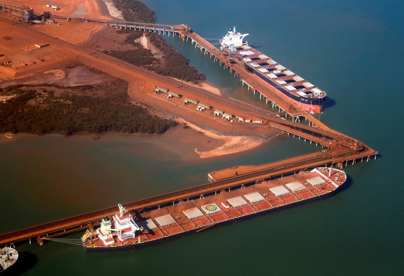 FILE PHOTO: Ships waiting to be loaded with iron ore are seen at the Fortescue loading dock located at Port Hedland, in the Pilbara region of Western Australia December 3, 2013.   REUTERS/David Gray/File Photo